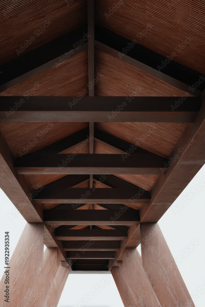 Obraz premium Interior metal structure with cross-shaped black steel beams and mesh panels illuminated by spotlights