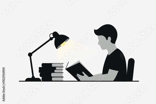 A silhouette of a person reading books illuminated by a desk lamp