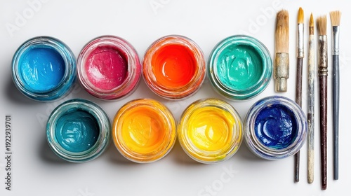 Wallpaper Mural Overhead of nine jars of paint, next to paintbrushes on a white surface, showcasing vibrant artistic colors Torontodigital.ca