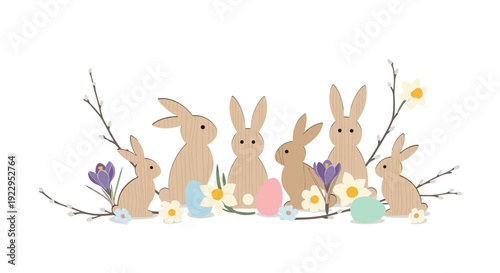 Arrangement of wooden rabbit figurines, colorful Easter eggs, pussy willow branches, and spring flowers on a white background.