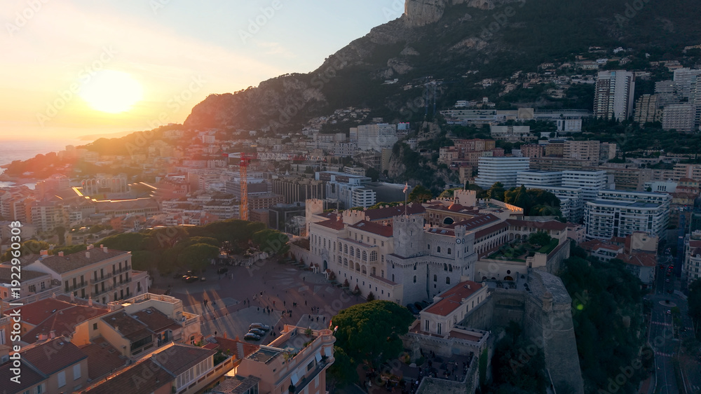 Fototapeta premium Aerial Cityscape Golden Hour Over Facades, Hillside Skyline And Coastal Bay Drone Sweeps Across Ornate Palace. Monaco