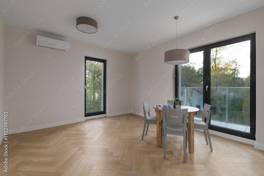 Fototapeta premium Modern bright kitchen interior with dining table and window