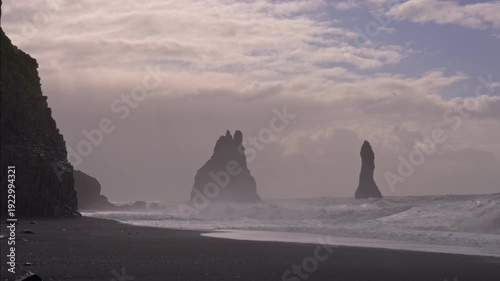 Basalt columns and crashing waves at Reynisfjara Beach in Iceland