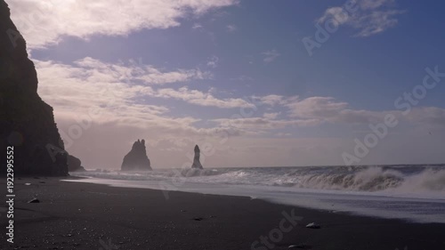 Basalt columns stand tall as waves crash on Reynisfjara Beach