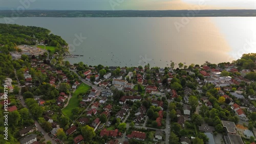 Panoramic view of Ammersee in Bavaria with floating boats, prealpine lake, serene shore, summer vacation, idyllic village, leisure, wide angle, tourism hotspot, natural beauty, peaceful waterfront. 