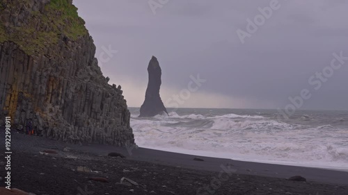 Basalt columns and crashing waves at Reynisfjara Beach in Iceland
