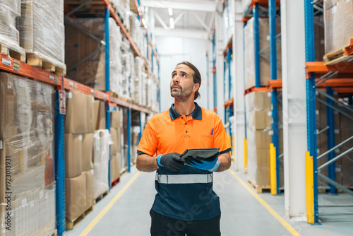 Warehouse worker using digital tablet checking stock and inventory