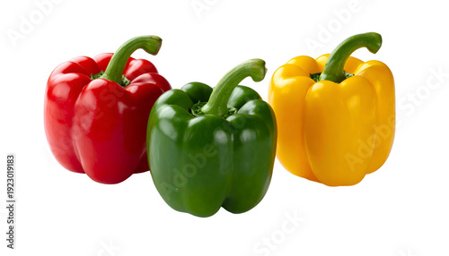 Three vibrantly colored bell peppers against a black background. One red, one green, one yellow