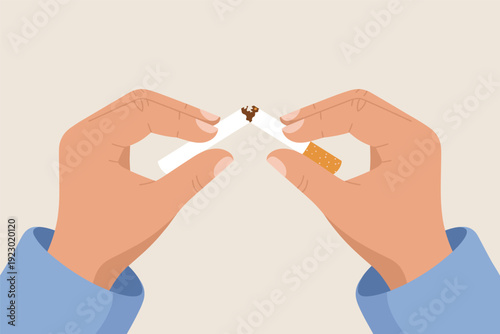 Person quitting smoking with broken cigarette in hands