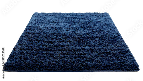 Angled view of a fluffy, rectangular, navy blue rug against a black backdrop