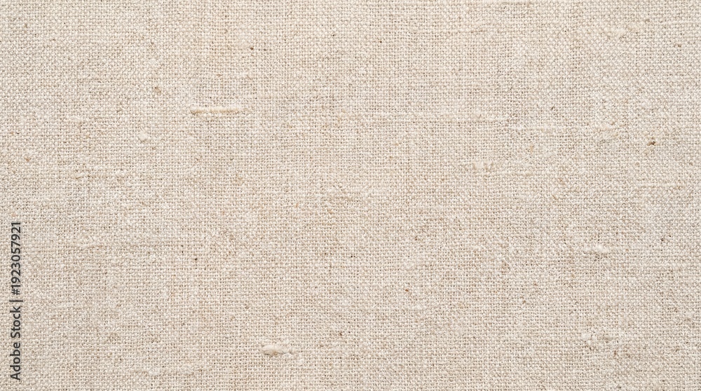 Fototapeta premium A close-up view of a textured undyed textile fabric with a plain weave showing natural fibers and slight irregularities in the surface