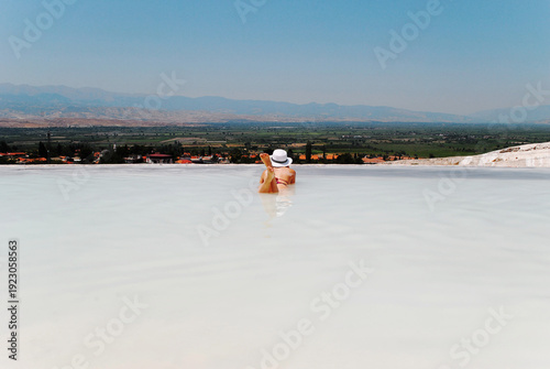 Woman relaxing in thermal pools at Pamukkale, Turkey, scenic travel destination with copy space