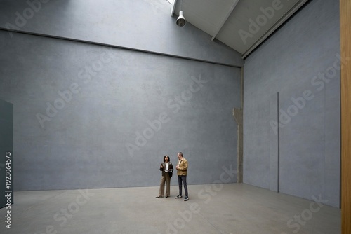 Visitors admire a roomy apartment with gray walls