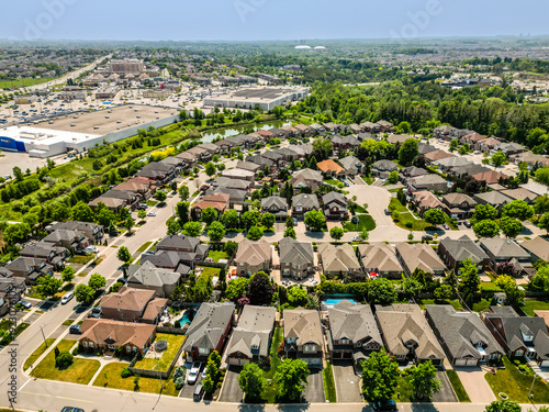 Bilde på lerret Aerial view of a modern suburban neighborhood with winding streets, clustered ho
