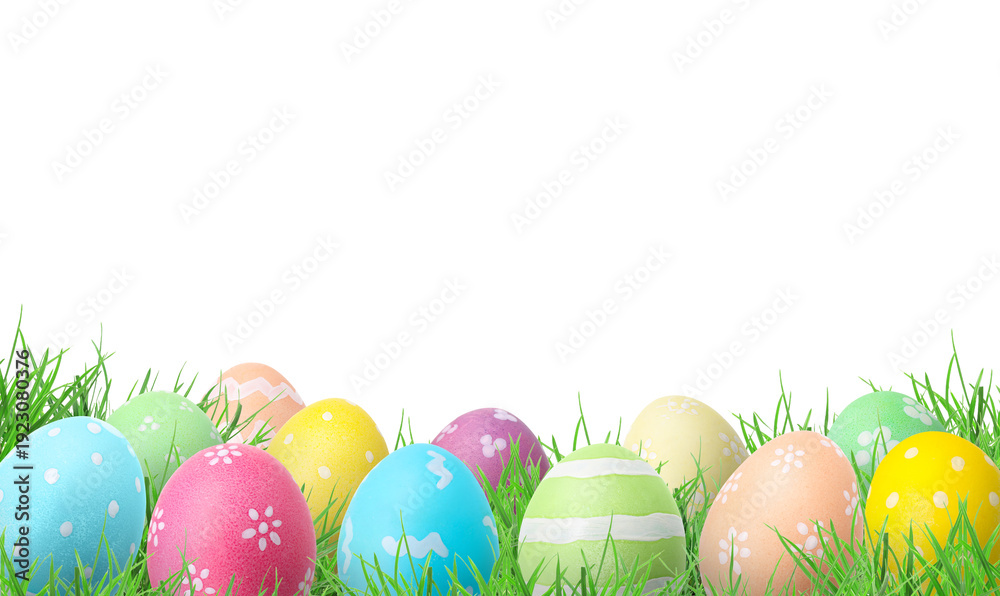 Fototapeta premium Easter eggs in green grass against white background