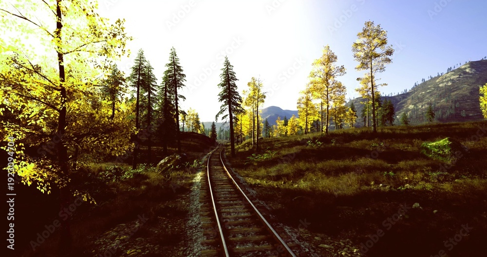Fototapeta premium Rail tracks winding through sunlit meadow toward distant mountains, vintage atmosphere with wooden sleepers and overgrown verge, warm late afternoon glow, sense
