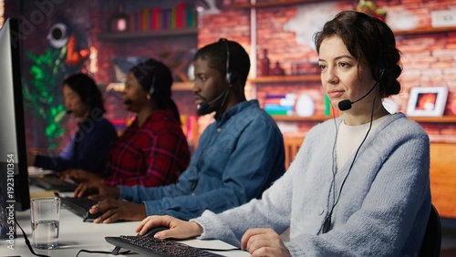 Friendly customer support workers respond to customers inquiries about products or services. Cheerful call center agent in office providing accurate and satisfactory information to customers, camera B