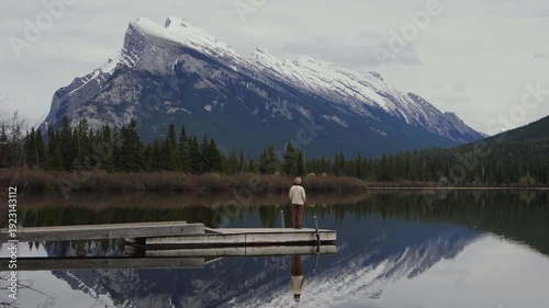 Wallpaper Mural Woman standing on a pier enjoying the scenic mountain views reflecting in Vermilion Lakes in Banff National Park Torontodigital.ca