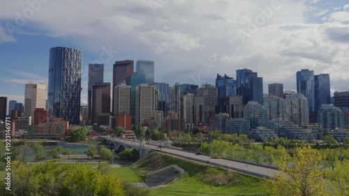 Wallpaper Mural Calgary city skyline featuring modern skyscrapers, residential buildings, bridge, and the Bow River in Canada Torontodigital.ca