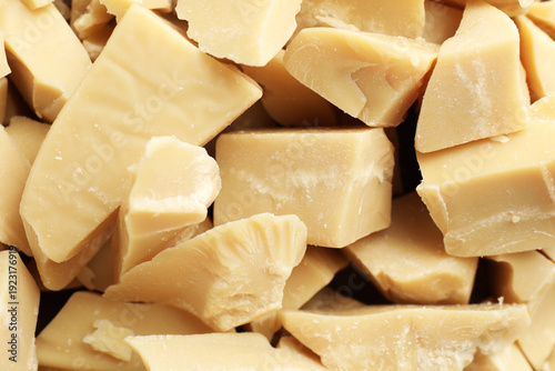 Cuadro en lienzo Pieces of natural cocoa butter as background, top view