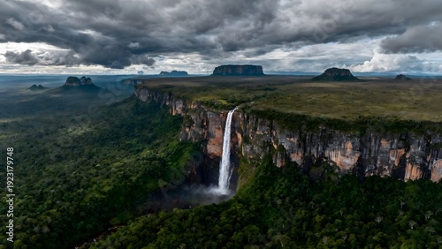 Wallpaper Mural Grand waterfall plunging from a high cliff into a vast, verdant landscape Torontodigital.ca