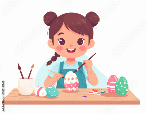 Cute little girl happily painting colorful Easter eggs at a wooden table in preparation for the spring holiday celebration
