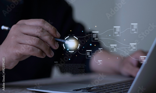 Photos Businessman holding pencil pointing at virtual document workflow flowchart on laptop