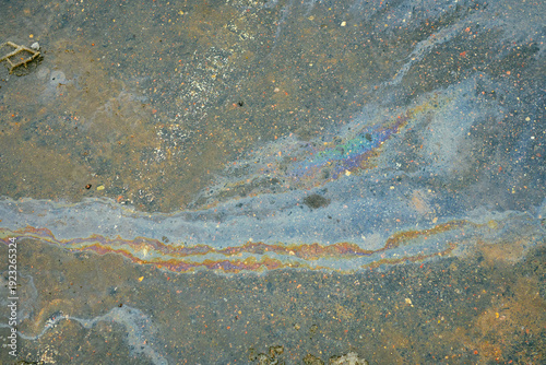 Photos Iridescent oil slick pollution with rainbow colors on wet asphalt surface creati