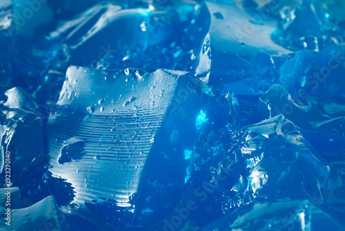 A closeup view of a pile of blue gelatin, as a background. 