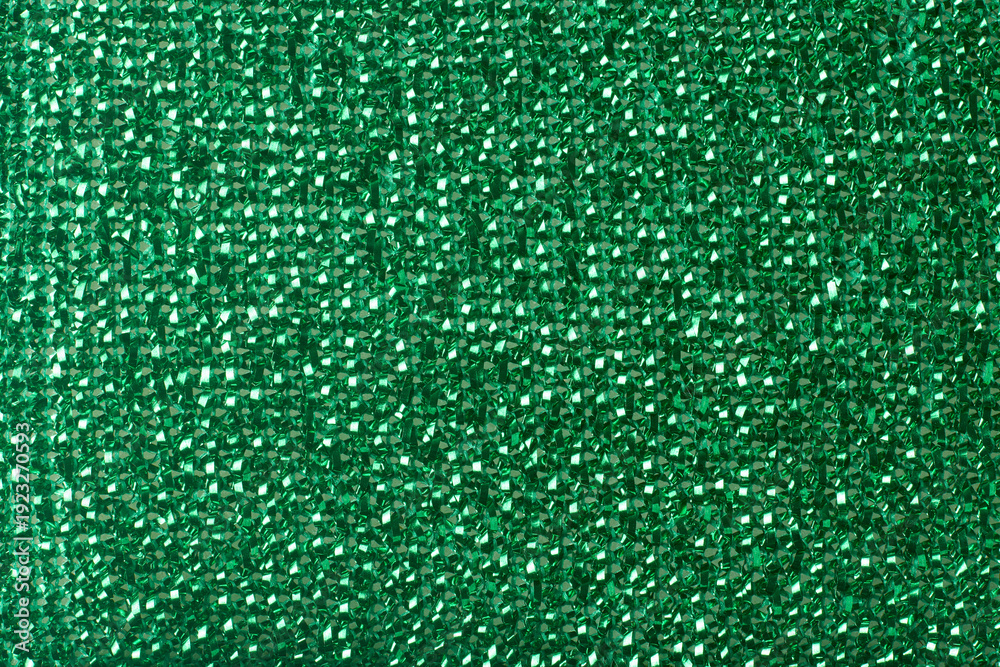 Fototapeta premium bright green plastic material texture background, shiny metallic finish with interwoven synthetic strands, full frame closeup, party theme background and festive concept