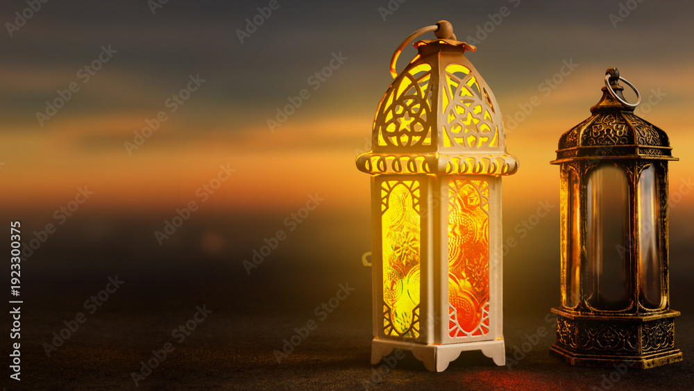 Fototapeta premium Two traditional Arabic lanterns glowing at dusk against a soft sunset sky. Perfect for Ramadan Kareem, Eid Mubarak, and Islamic holiday greetings. Plenty of copy space
