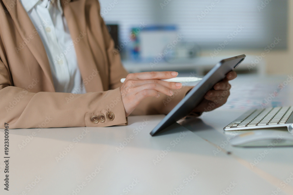 Obraz premium Close up of businessman using tablet in office for company, finance and asset management and hands touching screen.