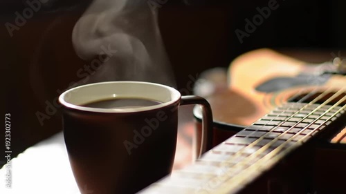 A steaming cup of black coffee sits beside an acoustic guitar, creating a cozy and musical atmosphere in the room.