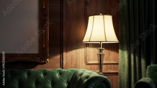 Elegant living room interior showcases a vintage lamp illuminating the luxurious green velvet armchairs and wooden wall.