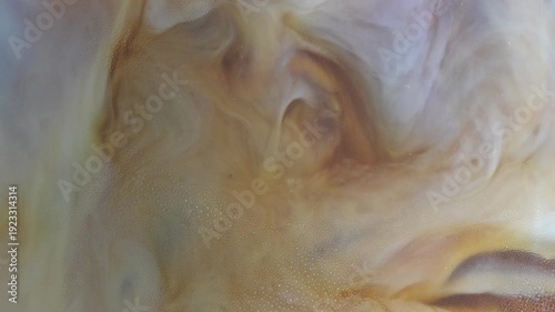 4K Milk swirling into coffee abstract marble patterns Close up beverage background with creamy texture, minimal cafe concept and soft liquid motion.