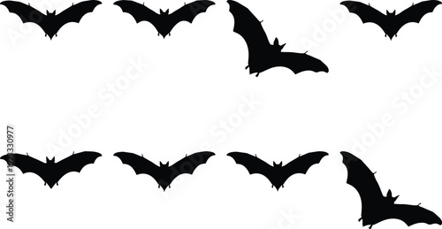 Flying silhouettes of bats in a dark night sky formation