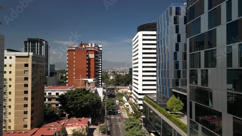 Low aerial flying between buildings in Guatemala City downtown on sunny day