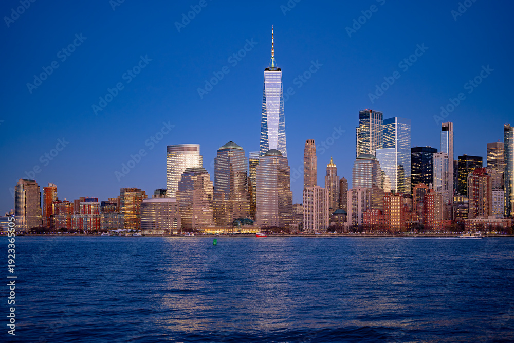 Obraz premium Manhattan cityscape over waterfront. NYC skyline scenic river view. New York City skyline iconic panorama. Manhattan skyline photography scene. NYC skyline modern American city.