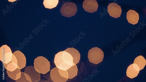 Soft bokeh lights in dark background for festive atmosphere  