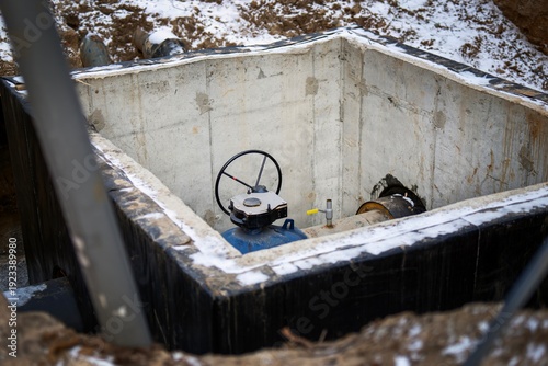 Wallpaper Mural Square concrete utility tunnel under construction in winter with hot water pipes, valves, and large handles. Urban infrastructure development. Torontodigital.ca