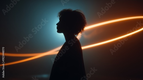 Silhouette of a woman against a vibrant backdrop featuring dynamic orange and blue neon light streaks, creating an ethereal atmosphere.