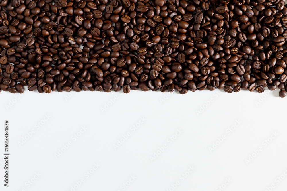 Fototapeta premium Top view of a roasted coffee beans, against a white background