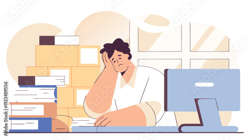 Frustrated man with head in hand feels burnout at a desk with a computer monitor surrounded by document piles.