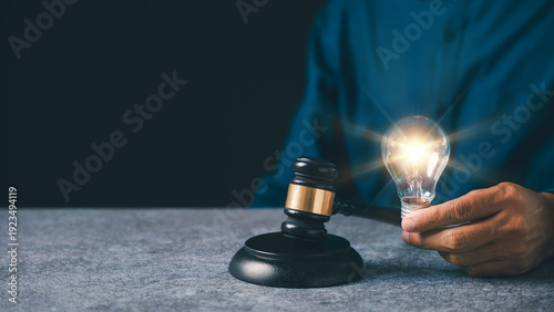 Quadro su tela Intellectual property patent law protects light bulb idea concept, hand holds gl