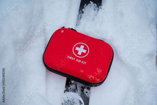 Rescue Kit Placed On Winter Ski Slope. Preparedness Essential Kit On Snow For Ski Rescue. Durable Emergency Medical Package Positioned On Snowy Terrain During Winter Sports Activity