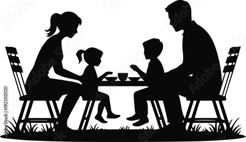 Children playing at table with parents nearby on lawn