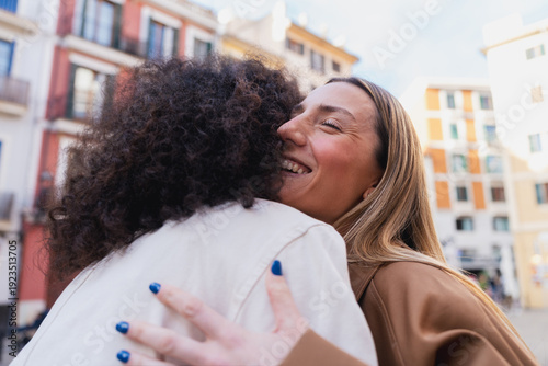 Young women friends embracing with feeling and connection