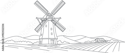 Windmill in rural landscape with farm and fields