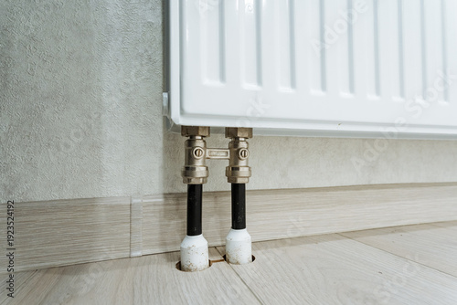 Heating System Components. Detailed View Of Plumbing Fittings. Closeup Of Radiator Valves And Pipes. Renovated Apartment Heating Connection With Metal Fittings And Valves
