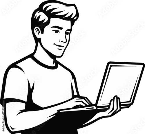A young man smiles as he types on a laptop computer